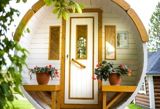 Viking Industrier 1.9m x 3m Sauna Barrel (SS193001) painted white with flower pot features on outside.