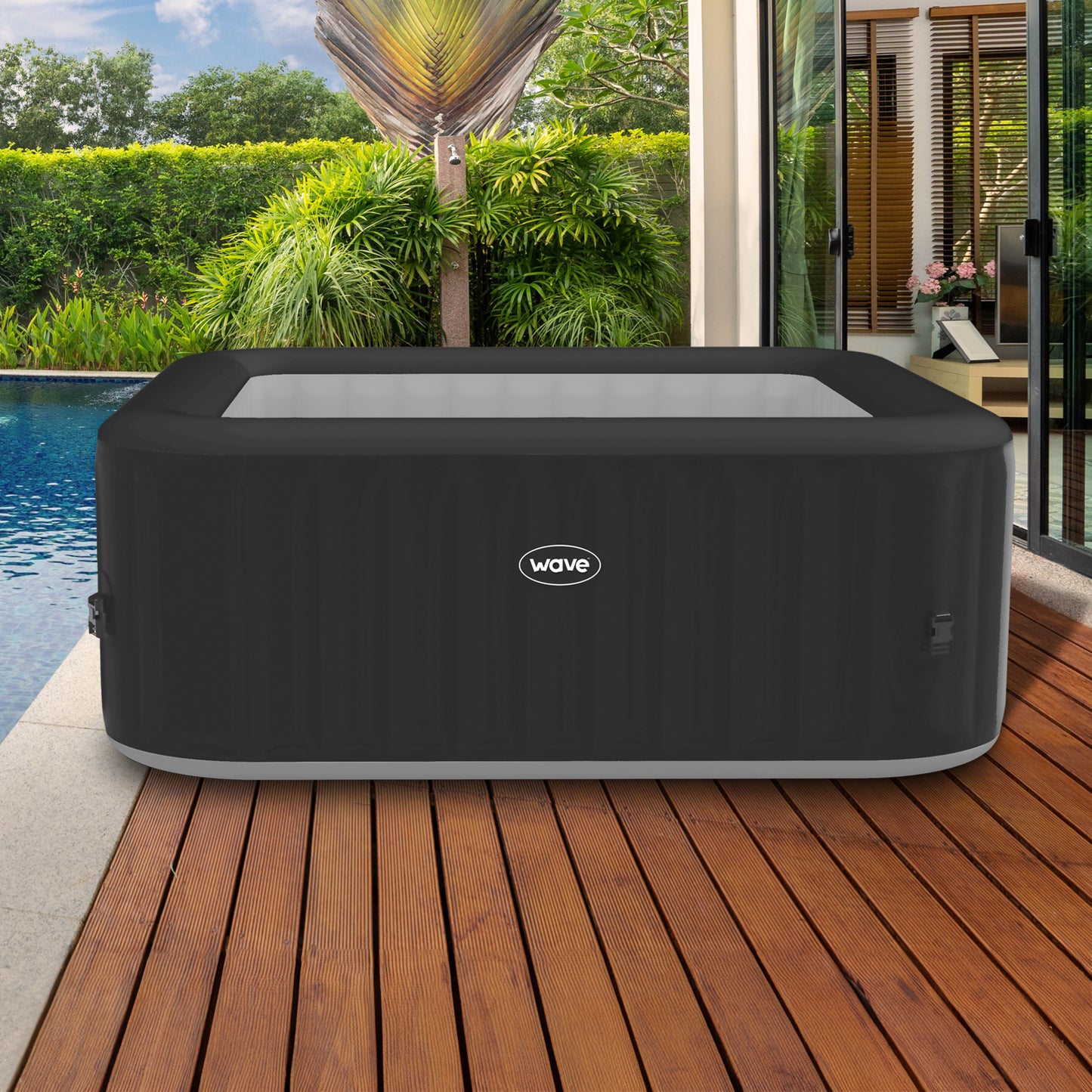 Pacific Wave Spas Grey Inflatable Hot Tub on decking area next to swimming pool.
