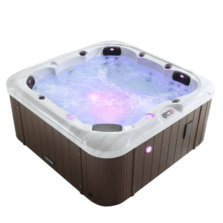 Cambridge Spa by Canadian Spa Company filled with water with purple LED lights and jets on. 