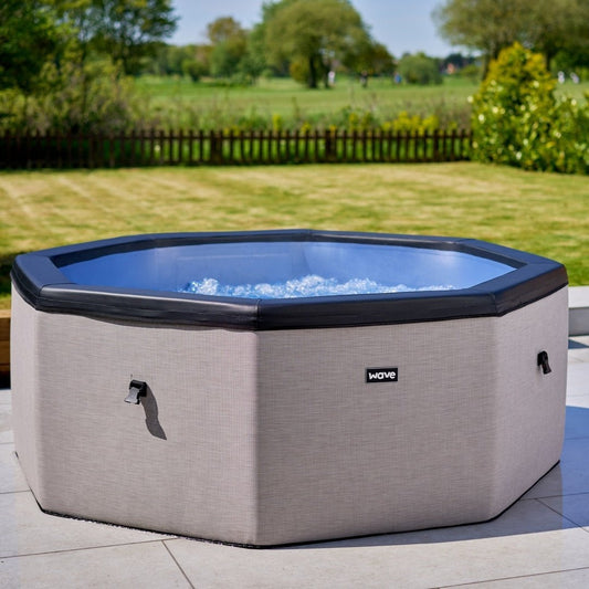 Como 6 Person Eco Foam spa in light grey showing wave logo in middle and bubbles inside the hot tub. 