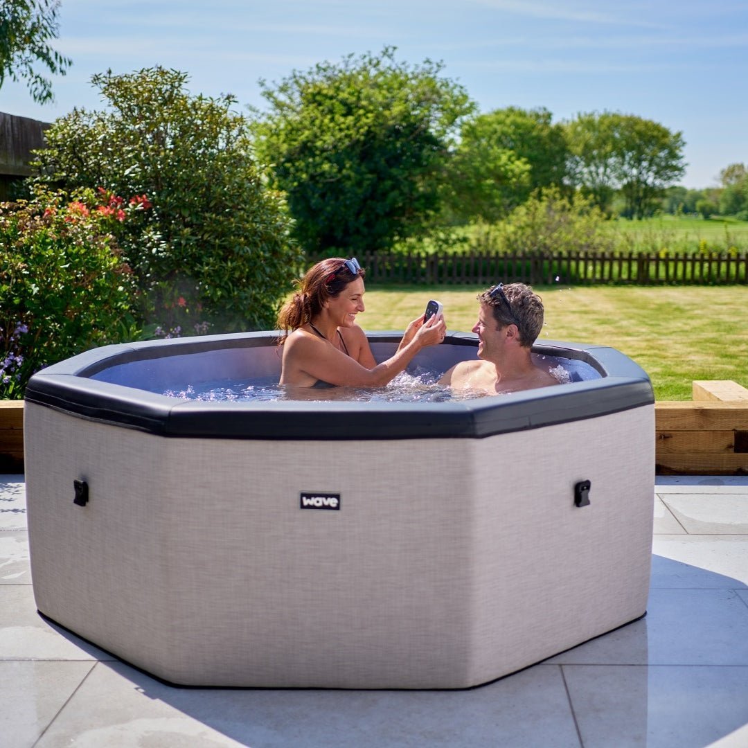 Couple enjoying the Como 6 person eco foam spa by Wave Spas. 