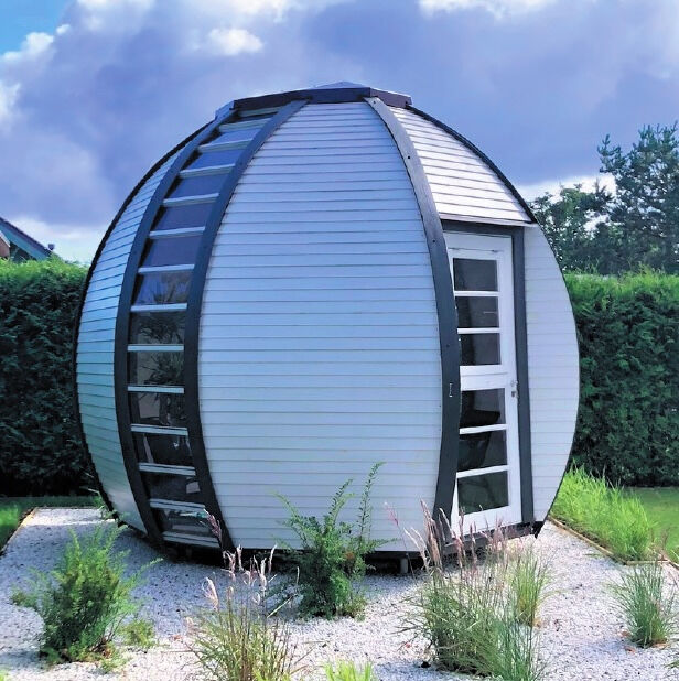 White painted Elegant Outdoor Garden room by Huuden in garden setting. 