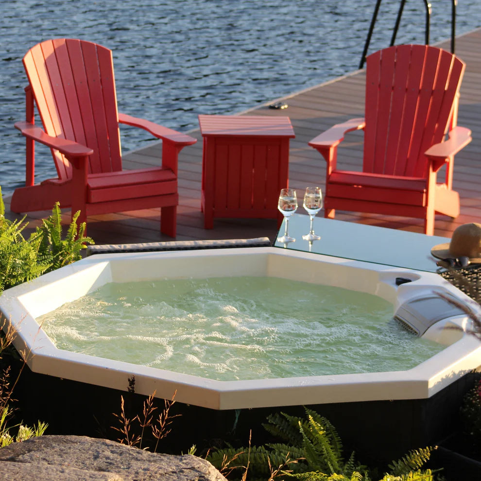 Muskoka 14-Jet 4-Person Spa lifestyle image showing glasses of wine next to hot tub. 