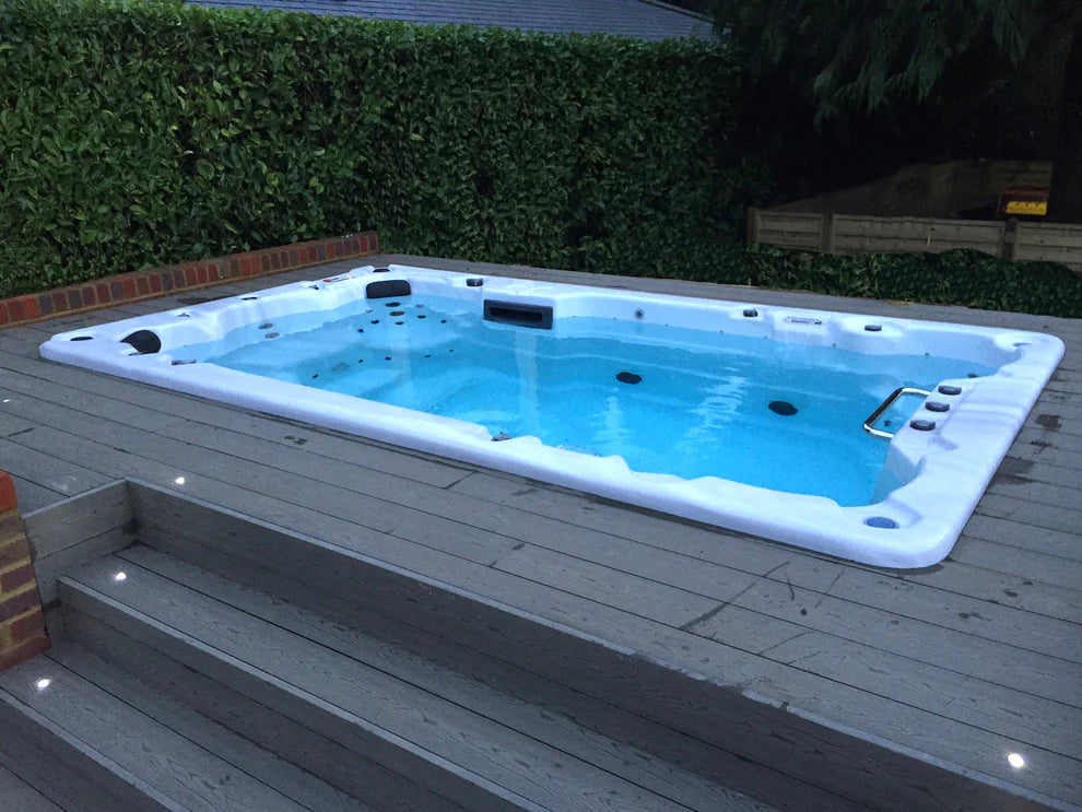 Canadian Spa Company St. Lawrence 13ft Swim Spa inset into garden decking area. 